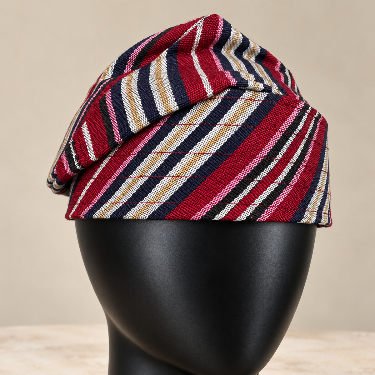 Multicoloured handmade Yoruba Fìlà cap, angled view