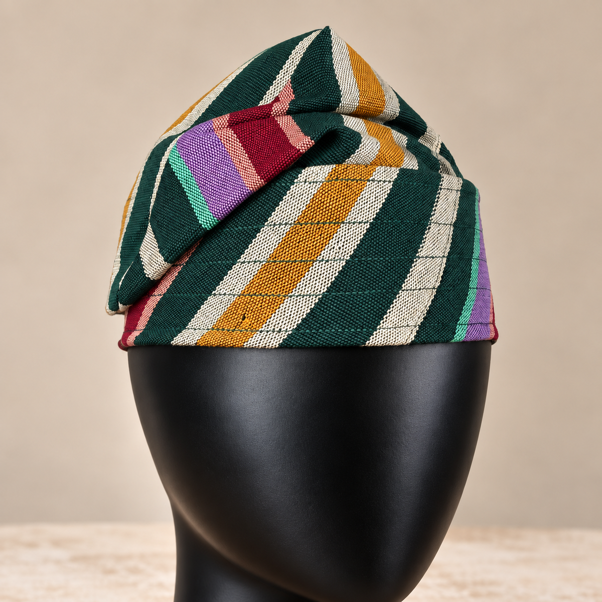 Multicoloured handmade Yoruba Fìlà cap, angled view