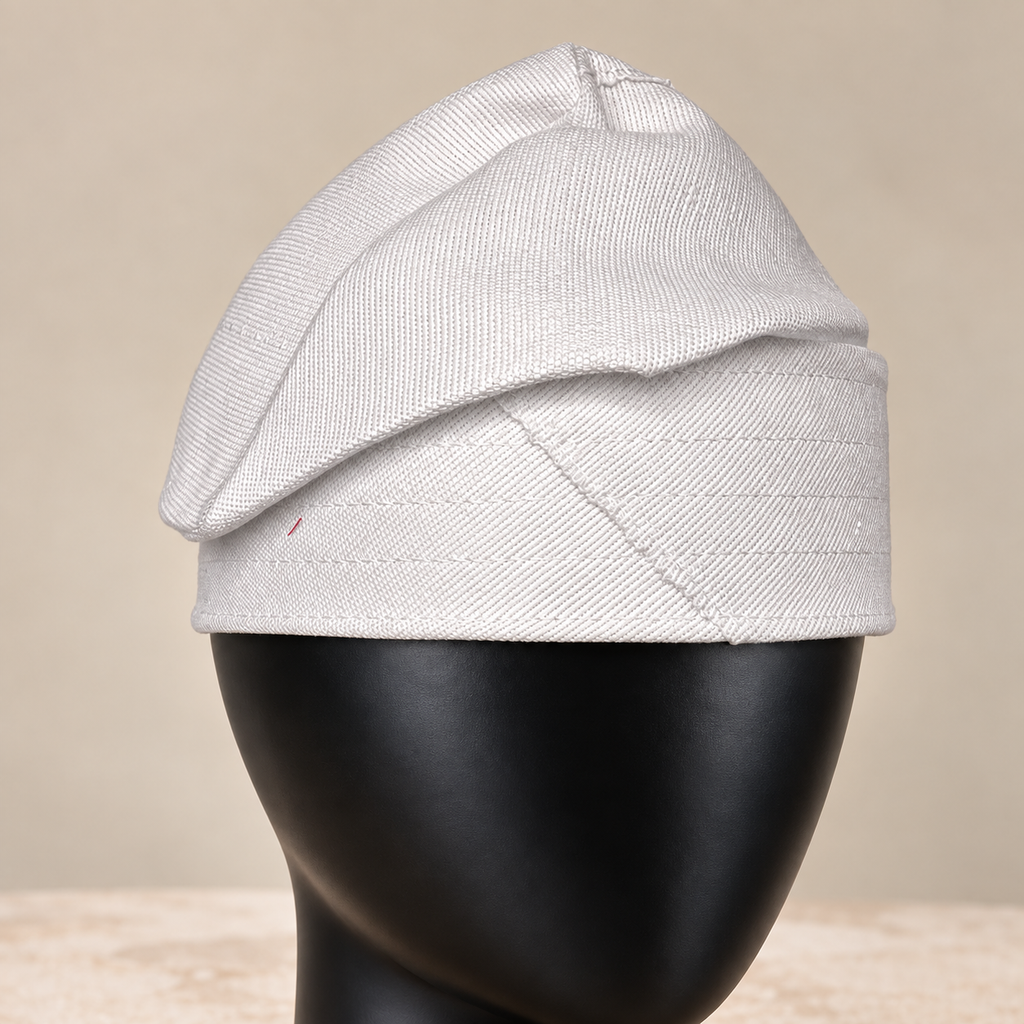 White handmade Yoruba Fìlà cap, angled view