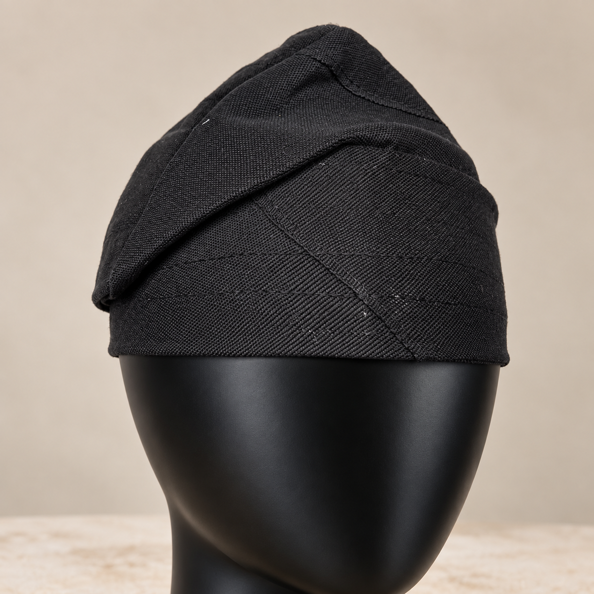 Black handmade Yoruba Fìlà cap, angled view
