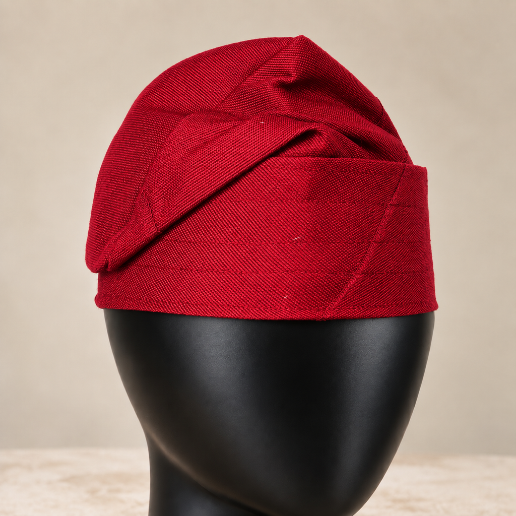 Red handmade Yoruba Fìlà cap, angled view