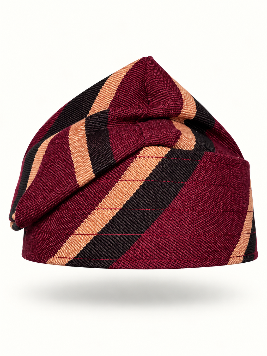 Red handmade Yoruba Fìlà cap on display