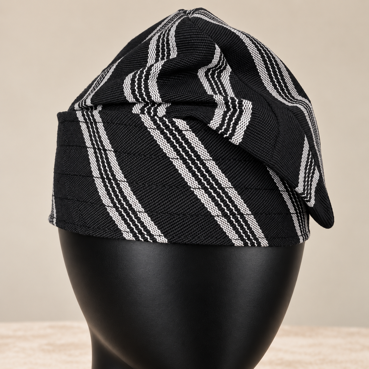 Black handmade Yoruba Fìlà cap, angled view