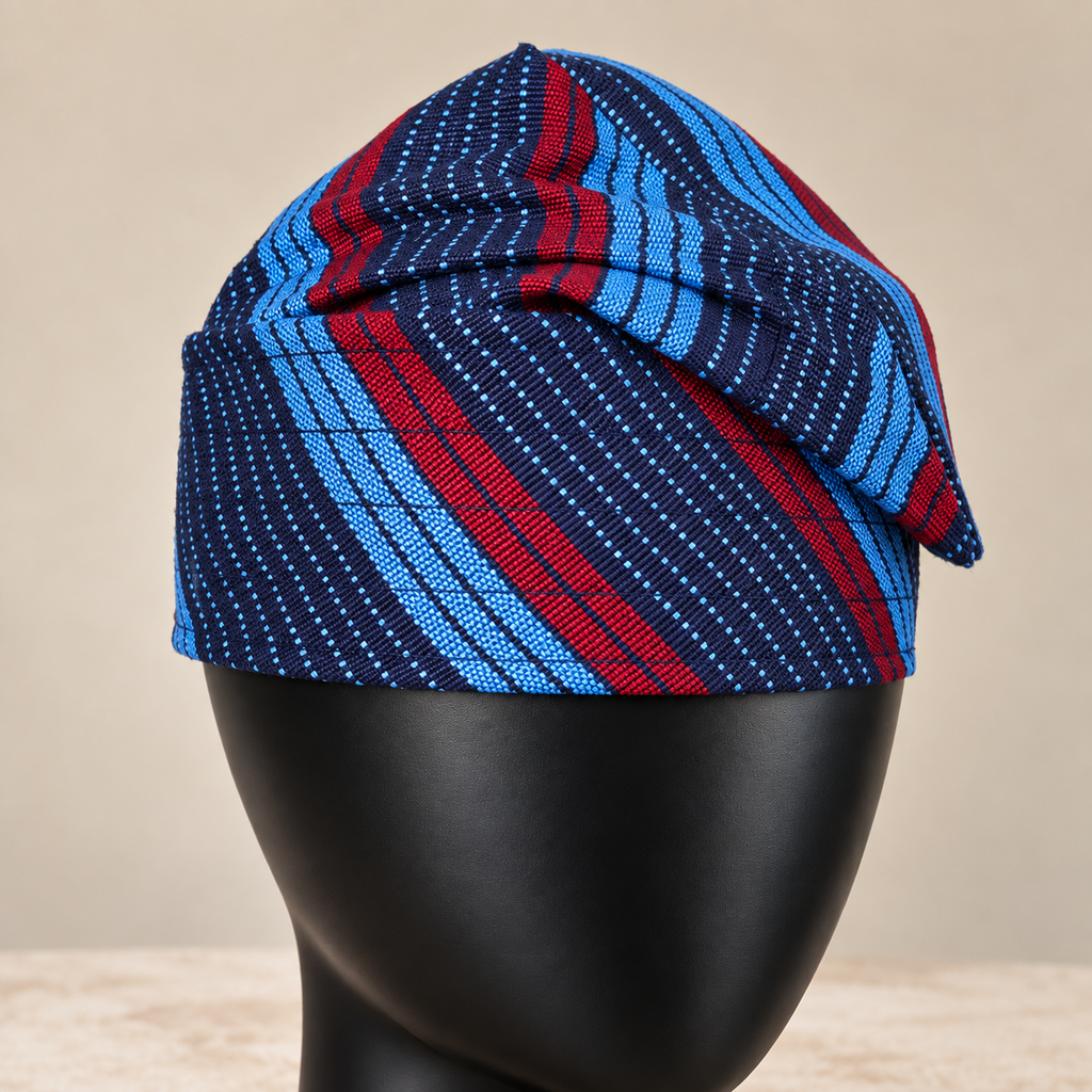 Blue handmade Yoruba Fìlà cap, angled view
