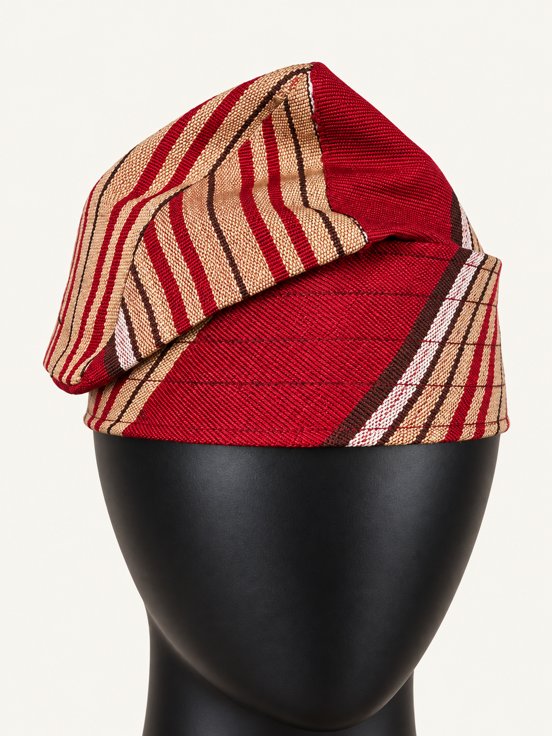 Red handmade Yoruba Fìlà cap, angled view