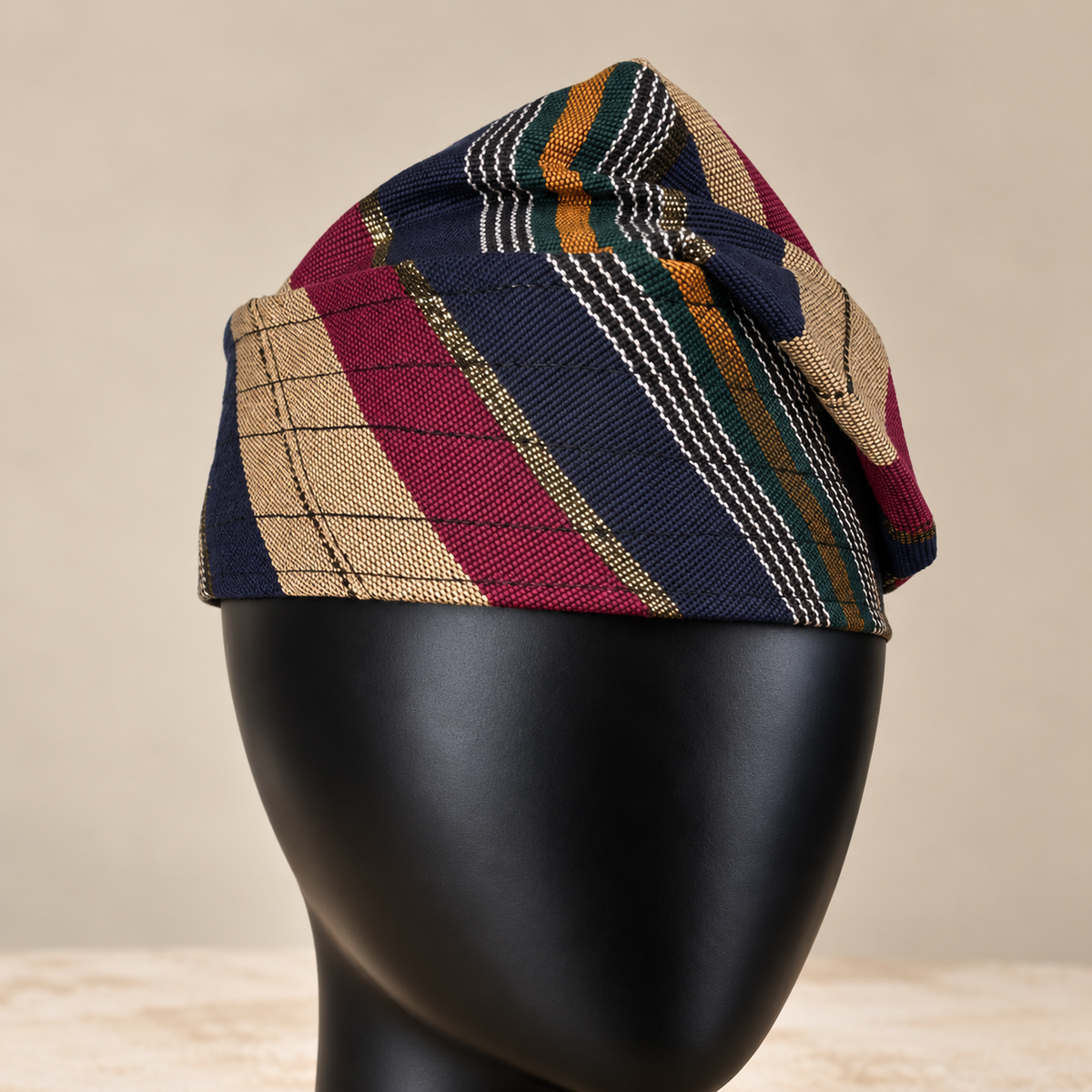 Multicoloured handmade Yoruba Fìlà cap, angled view