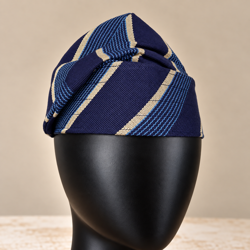 Blue handmade Yoruba Fìlà cap, angled view