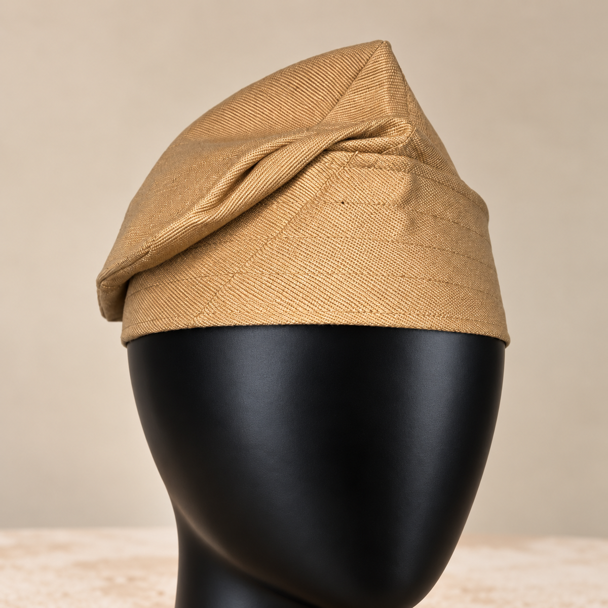 Gold handmade Yoruba Fìlà cap, angled view