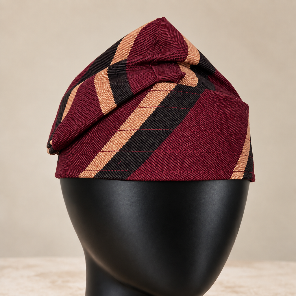 Red handmade Yoruba Fìlà cap, angled view