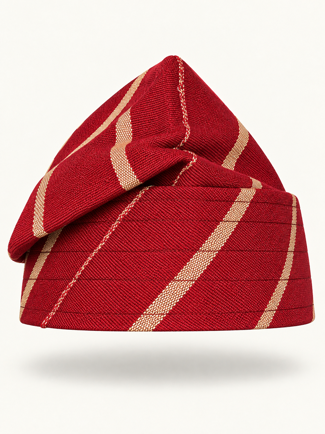 Red handmade Yoruba Fìlà cap on display