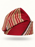 Red handmade Yoruba Fìlà cap on display