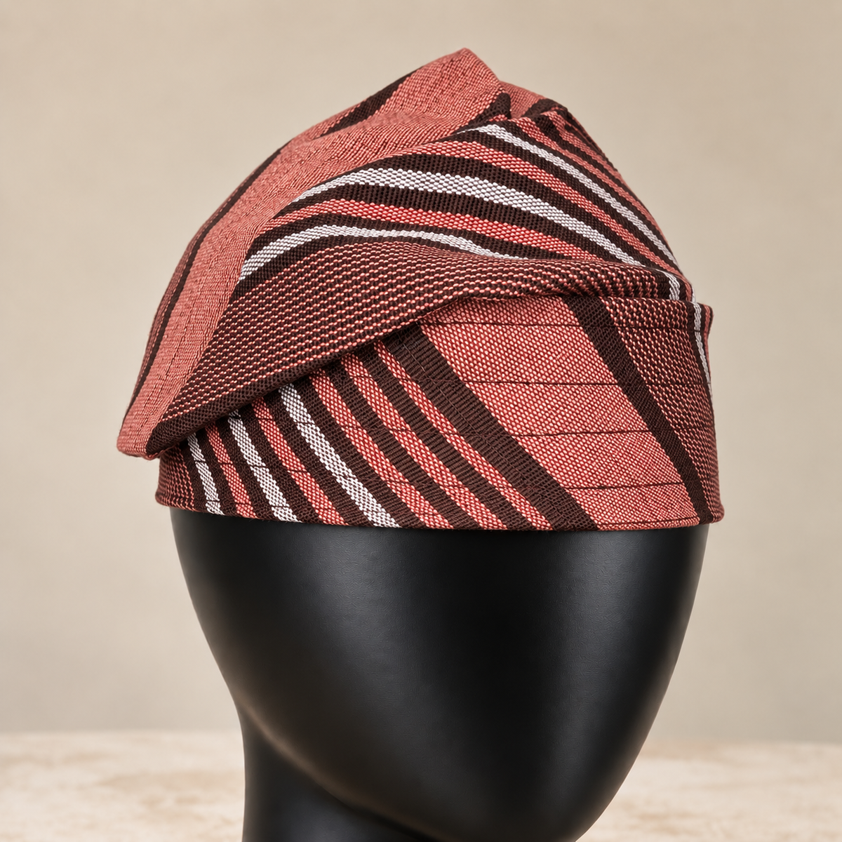 Brown handmade Yoruba Fìlà cap, angled view